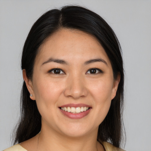 Joyful asian young-adult female with medium  brown hair and brown eyes