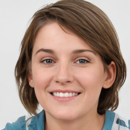 Joyful white young-adult female with medium  brown hair and blue eyes