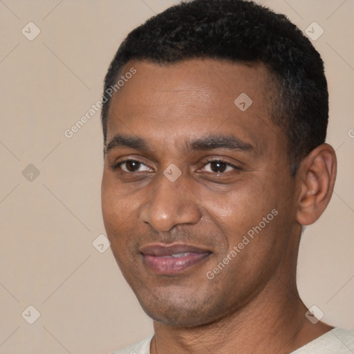 Joyful black young-adult male with short  black hair and brown eyes