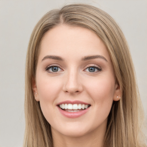 Joyful white young-adult female with long  brown hair and green eyes