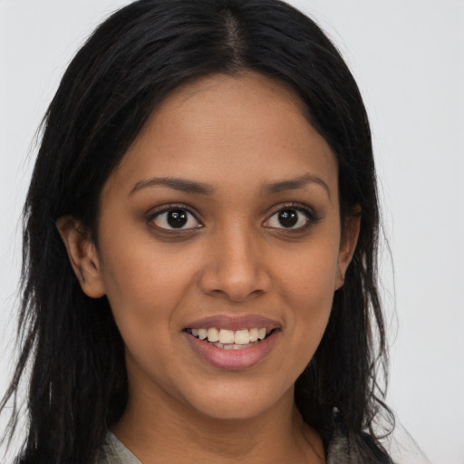 Joyful latino young-adult female with long  brown hair and brown eyes