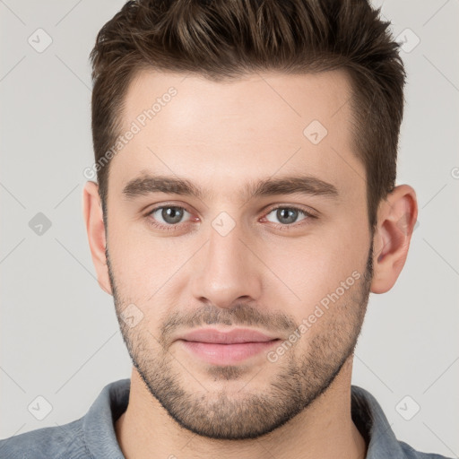 Joyful white young-adult male with short  brown hair and brown eyes