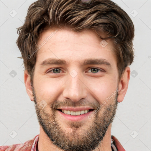 Joyful white young-adult male with short  brown hair and grey eyes