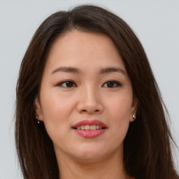 Joyful asian young-adult female with long  brown hair and brown eyes