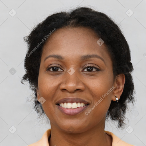 Joyful black adult female with medium  brown hair and brown eyes