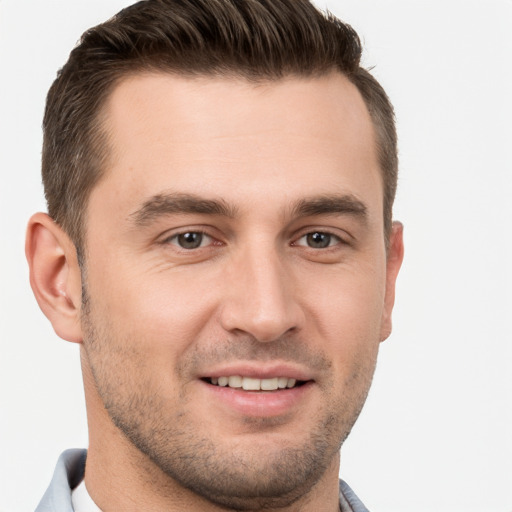 Joyful white young-adult male with short  brown hair and brown eyes