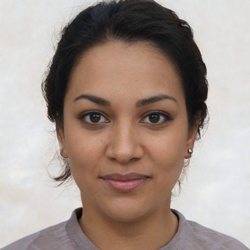 Joyful latino young-adult female with short  brown hair and brown eyes