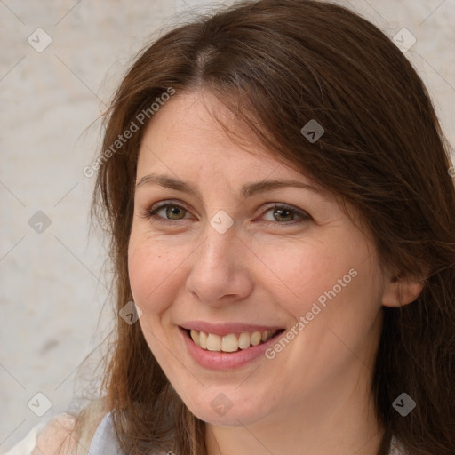 Joyful white adult female with medium  brown hair and brown eyes