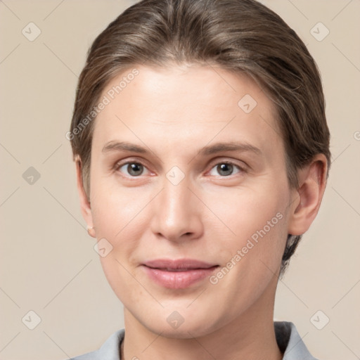 Joyful white young-adult female with short  brown hair and grey eyes