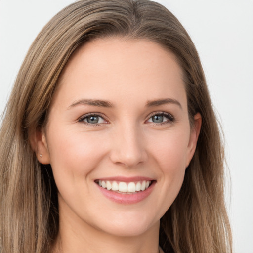 Joyful white young-adult female with long  brown hair and green eyes