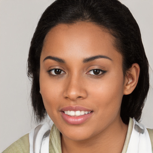 Joyful latino young-adult female with medium  brown hair and brown eyes