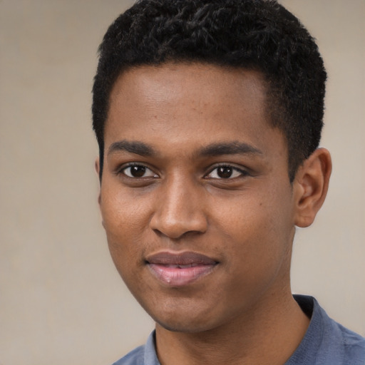 Joyful black young-adult male with short  black hair and brown eyes