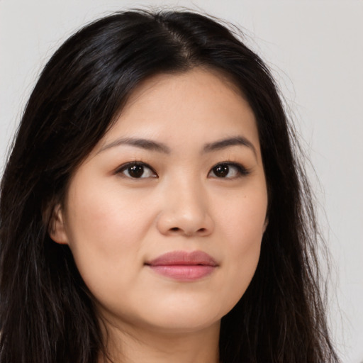 Joyful asian young-adult female with long  brown hair and brown eyes