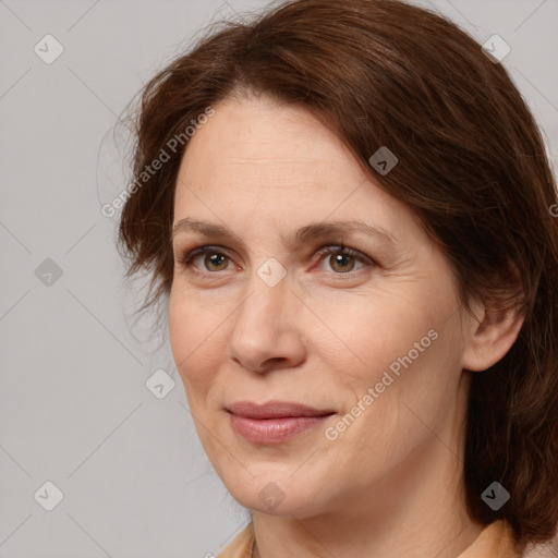 Joyful white adult female with medium  brown hair and brown eyes