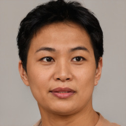 Joyful asian adult female with short  brown hair and brown eyes