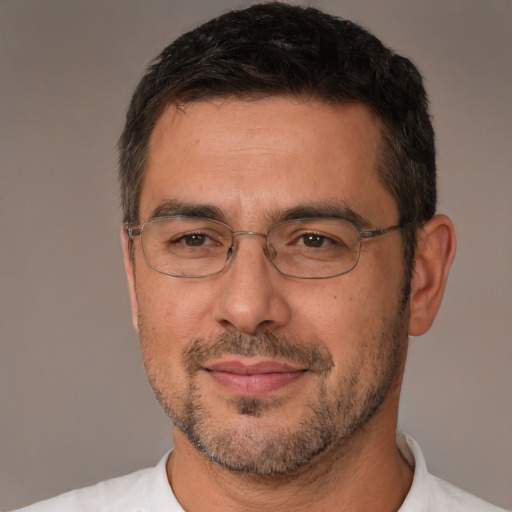 Joyful white adult male with short  brown hair and brown eyes