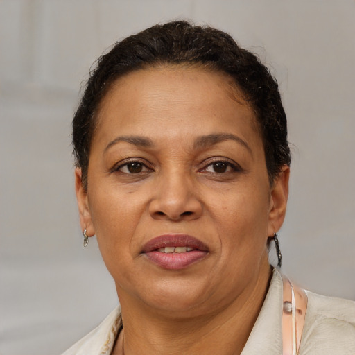 Joyful black adult female with short  brown hair and brown eyes