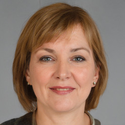 Joyful white adult female with medium  brown hair and grey eyes