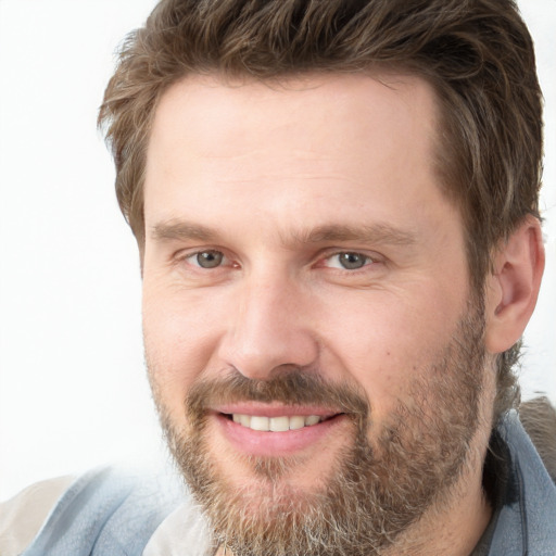 Joyful white adult male with short  brown hair and grey eyes