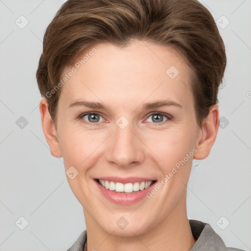 Joyful white young-adult female with short  brown hair and grey eyes