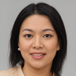 Joyful asian young-adult female with medium  brown hair and brown eyes