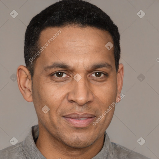 Joyful latino adult male with short  brown hair and brown eyes