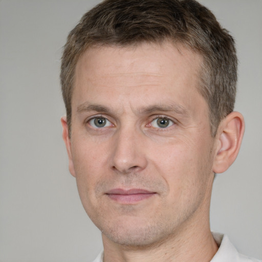 Joyful white adult male with short  brown hair and grey eyes