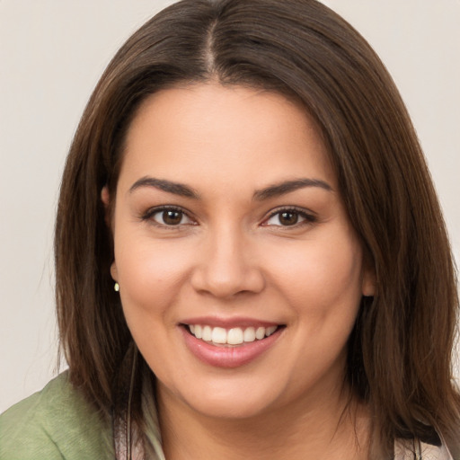 Joyful white young-adult female with long  brown hair and brown eyes