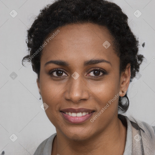 Joyful black young-adult female with short  black hair and brown eyes