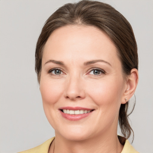 Joyful white young-adult female with medium  brown hair and brown eyes