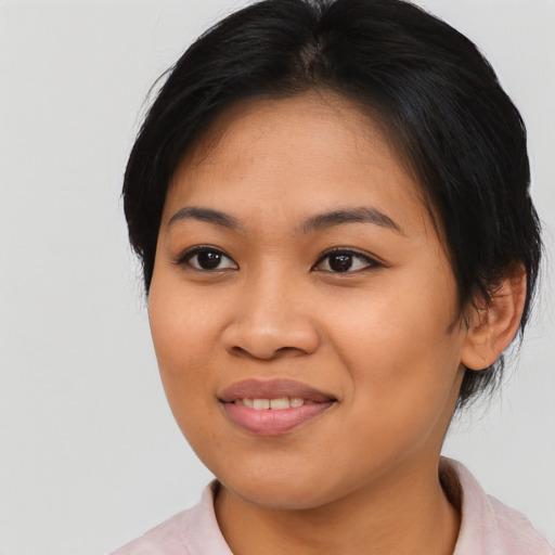 Joyful asian young-adult female with medium  black hair and brown eyes