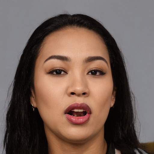 Joyful asian young-adult female with long  black hair and brown eyes