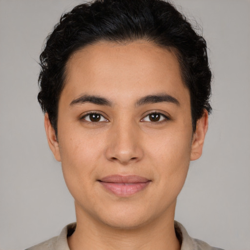 Joyful latino young-adult male with short  brown hair and brown eyes