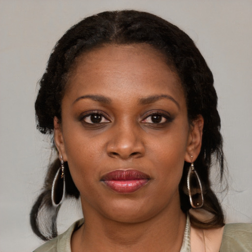 Joyful black young-adult female with medium  brown hair and brown eyes