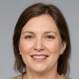 Joyful white adult female with medium  brown hair and brown eyes