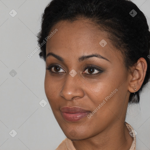 Joyful black young-adult female with short  brown hair and brown eyes