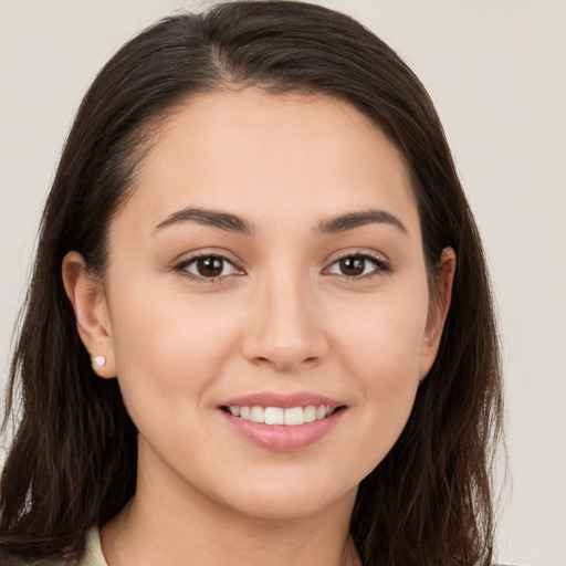 Joyful white young-adult female with long  brown hair and brown eyes