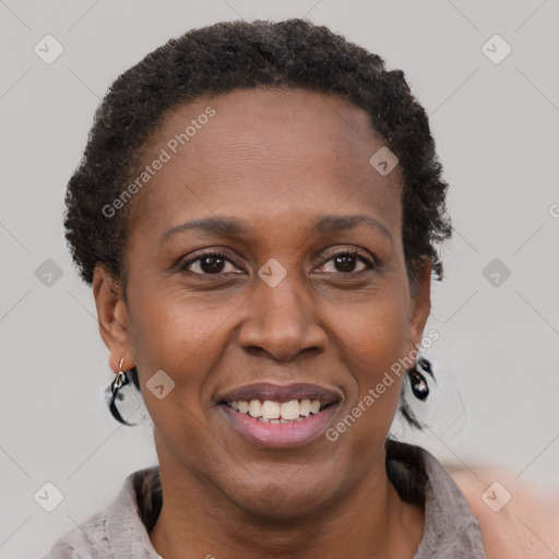 Joyful black adult female with short  brown hair and brown eyes