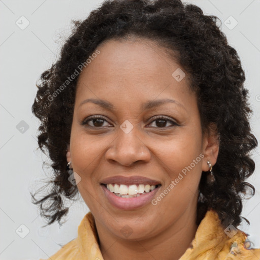 Joyful black young-adult female with long  brown hair and brown eyes