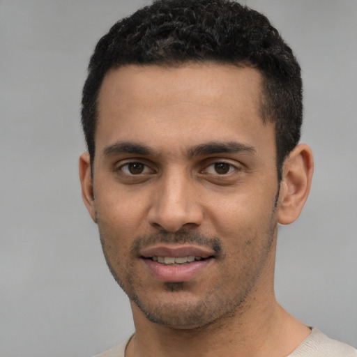Joyful white young-adult male with short  black hair and brown eyes
