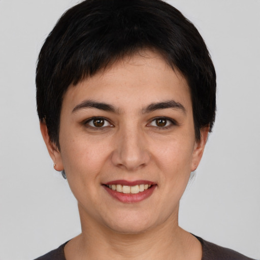 Joyful white young-adult female with short  black hair and brown eyes