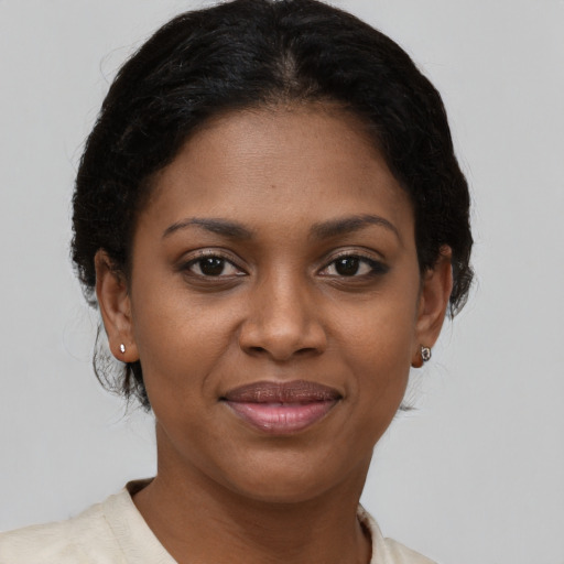 Joyful black young-adult female with short  brown hair and brown eyes