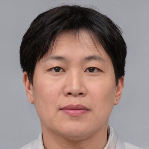 Joyful asian adult male with short  brown hair and brown eyes