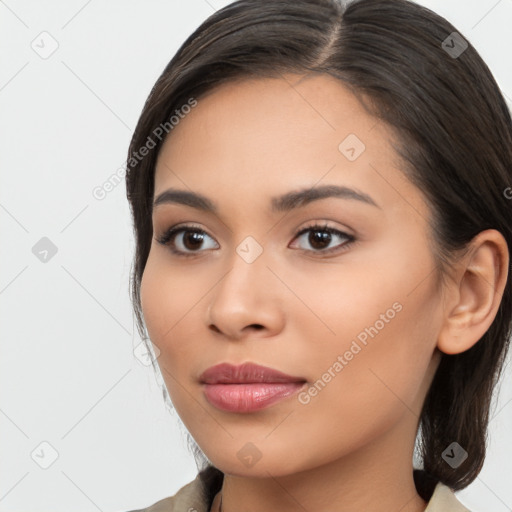 Joyful latino young-adult female with long  brown hair and brown eyes