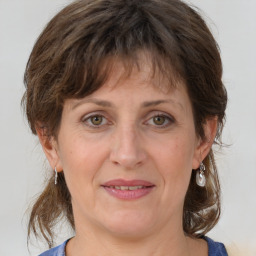 Joyful white adult female with medium  brown hair and grey eyes