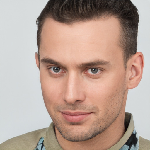 Joyful white young-adult male with short  brown hair and brown eyes