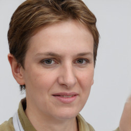 Joyful white adult female with medium  brown hair and grey eyes