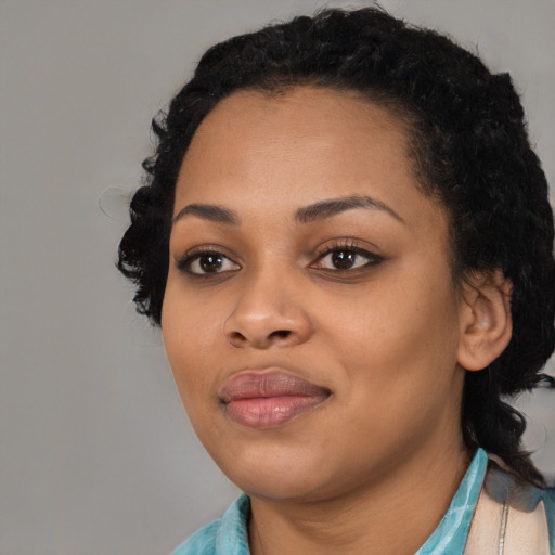 Joyful black young-adult female with medium  black hair and brown eyes