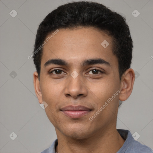 Joyful latino young-adult male with short  brown hair and brown eyes