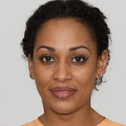 Joyful black young-adult female with short  black hair and brown eyes